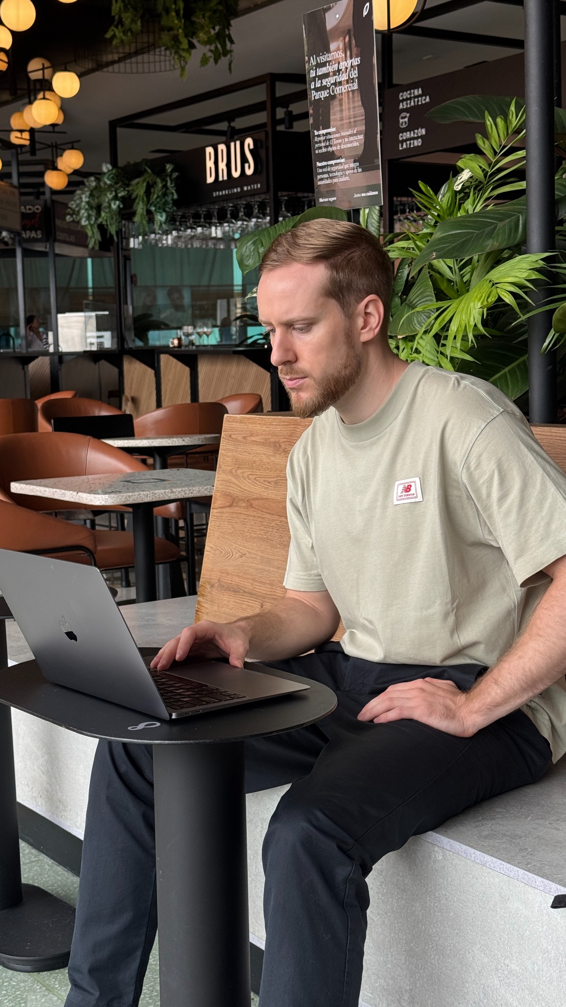 Matt working on his laptop at a café